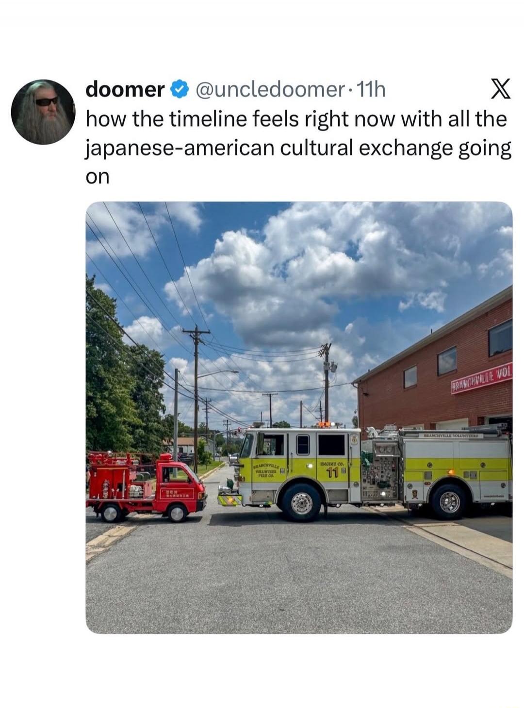 doomer @uncledoomer · 11h how the timeline feels right now with all the japanese-american cultural exchange going on. A large American fire truck from Branchville Volunteers Fire Co. Engine Co. 11 is parked next to a much smaller, red Japanese-style mini fire truck. The building in the background says 'BRANCHVILLE VOL'.