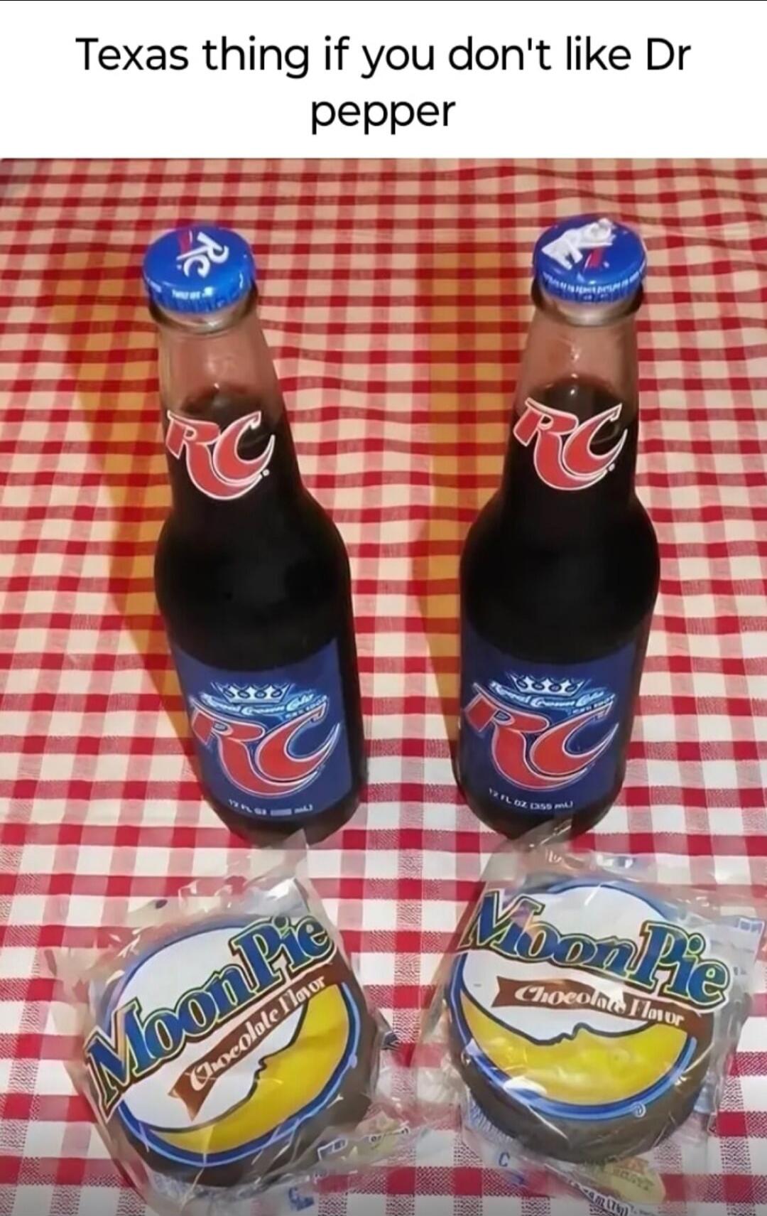 Texas thing if you don't like Dr pepper. Two bottles of RC Cola and two MoonPie Chocolate Flavor snacks are displayed on a red and white checkered tablecloth.