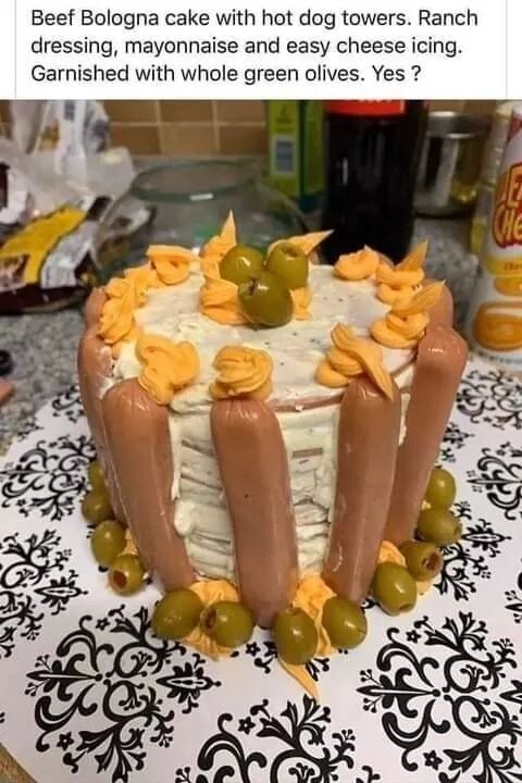Beef Bologna cake with hot dog towers Ranch dressing mayonnaise and easy cheese icing Garnished with whole green olives Yes