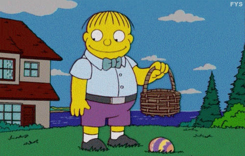 Ralph Wiggum from The Simpsons finds an Easter egg on the ground, picks it up, and then eats it whole.