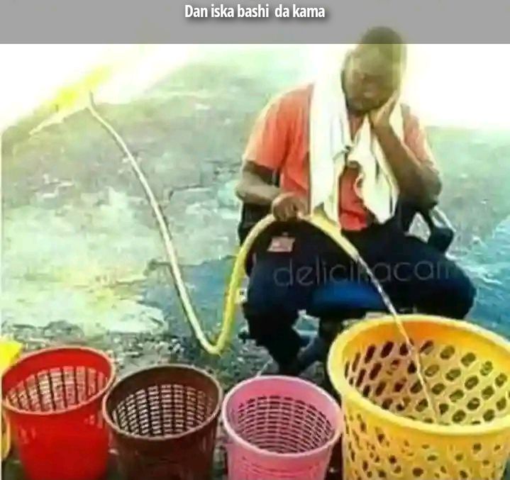 Dan iska bashi da kama. A man is pouring water from a hose into a leaky plastic basket.