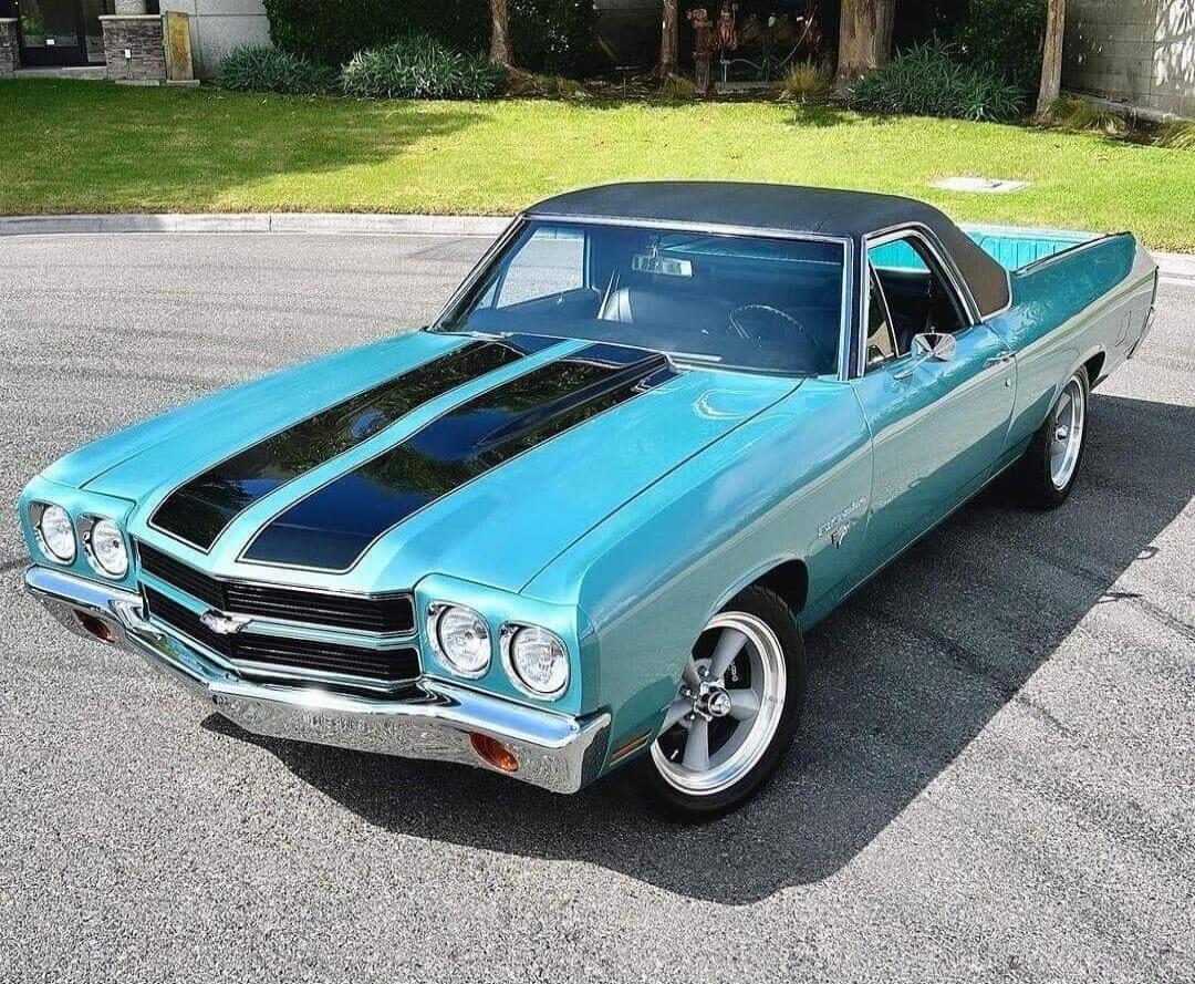 Turquoise classic car with black racing stripes (Chevelle).