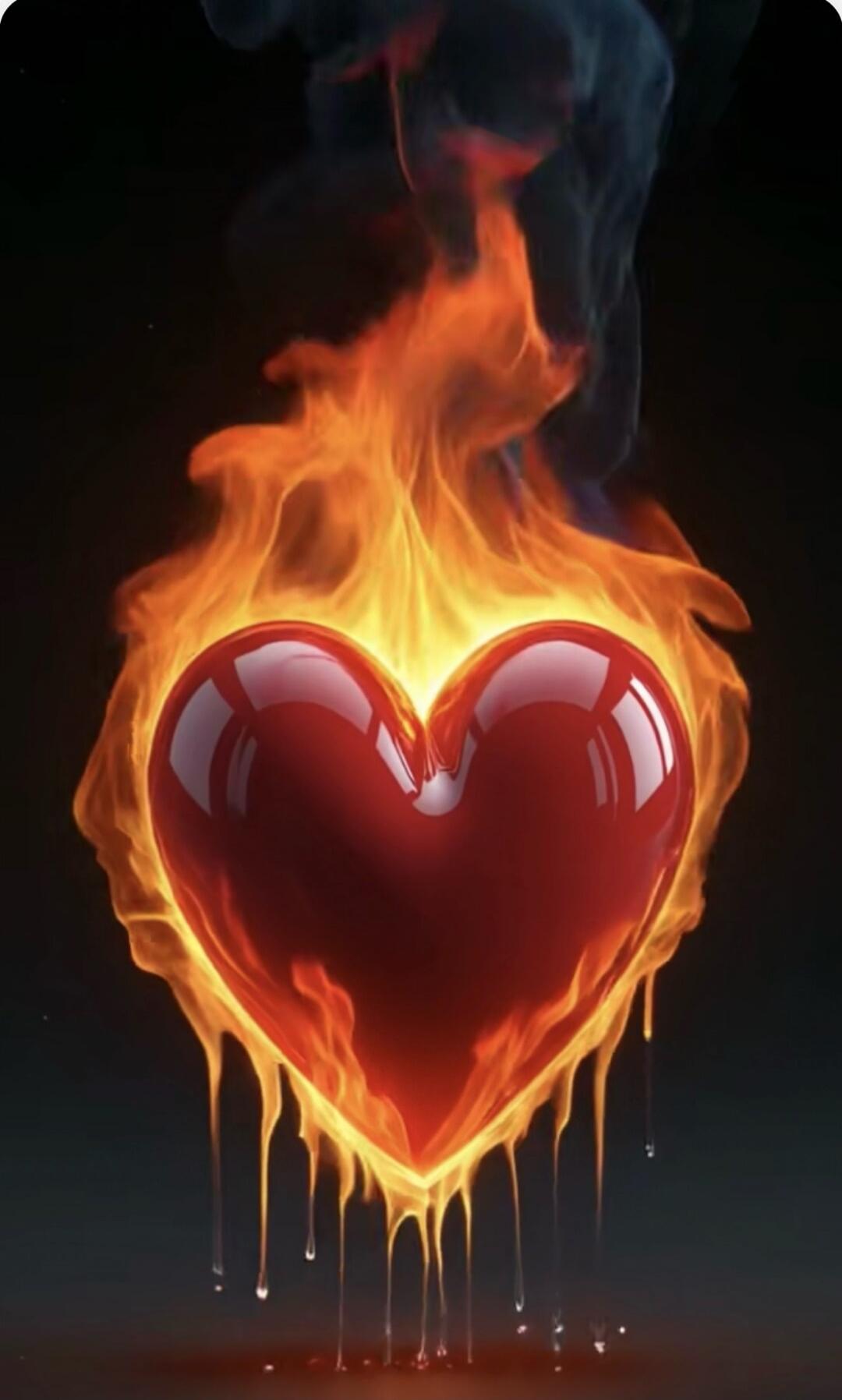 A glossy red heart engulfed in vibrant flames, with fiery drips at the bottom against a dark background.