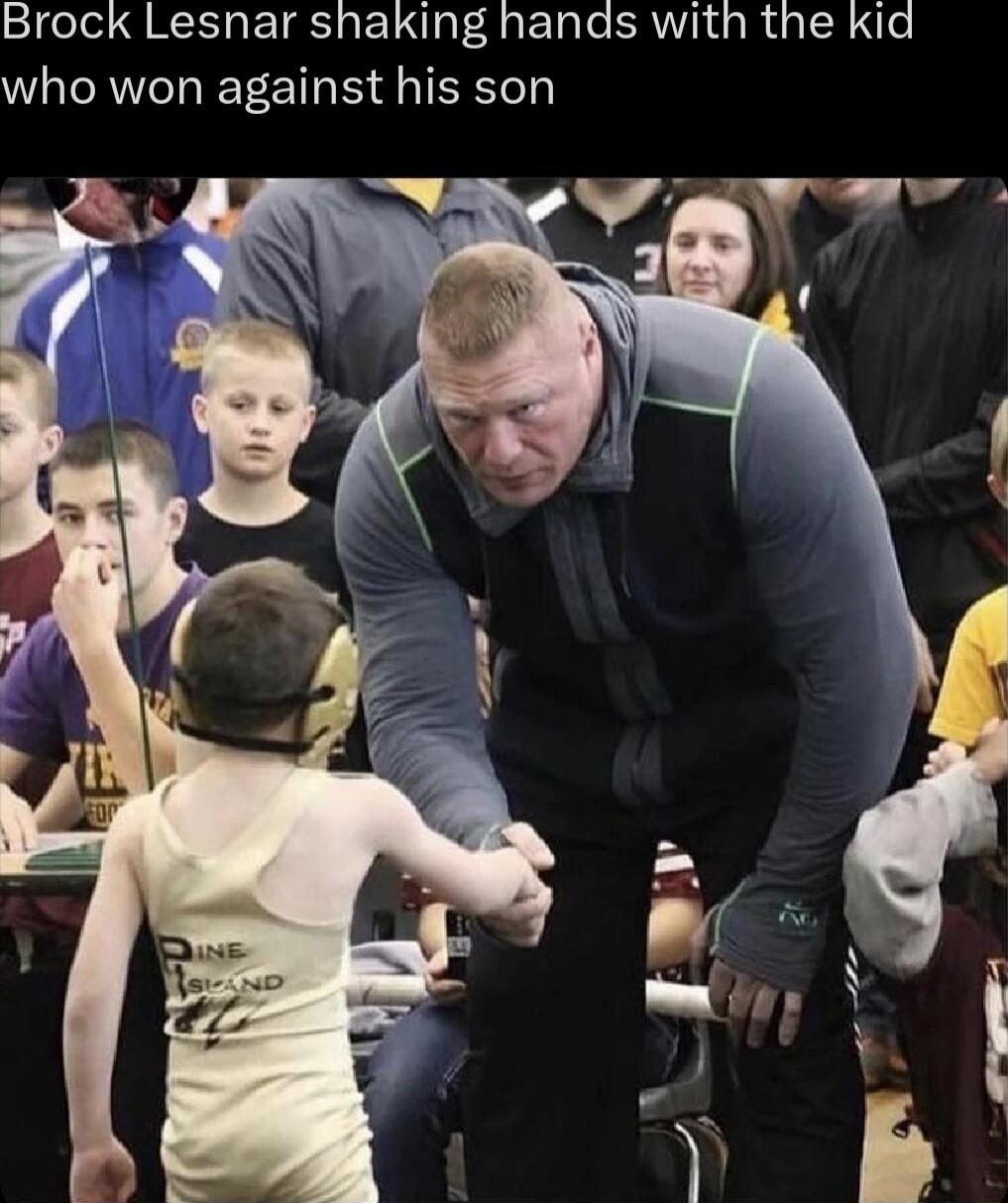Brock Lesnar shaking hands with the kid who won against his son