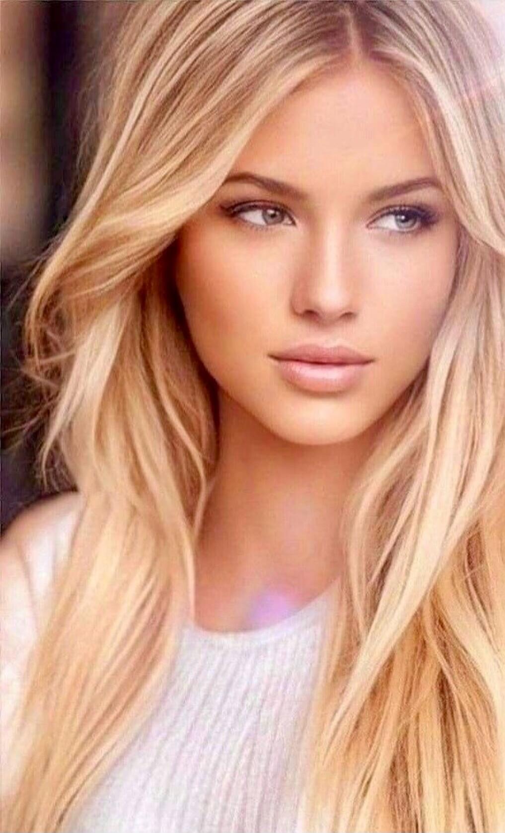 Portrait of a blonde woman looking to the side.