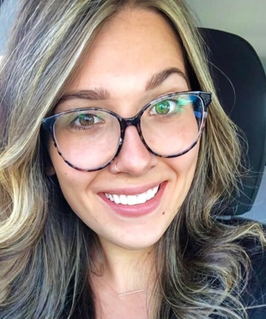 A smiling woman wearing glasses.