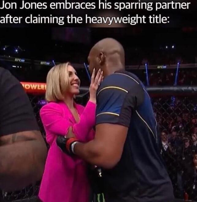 Jon Jones embraces his sparring partner after claiming the heavyweight title
