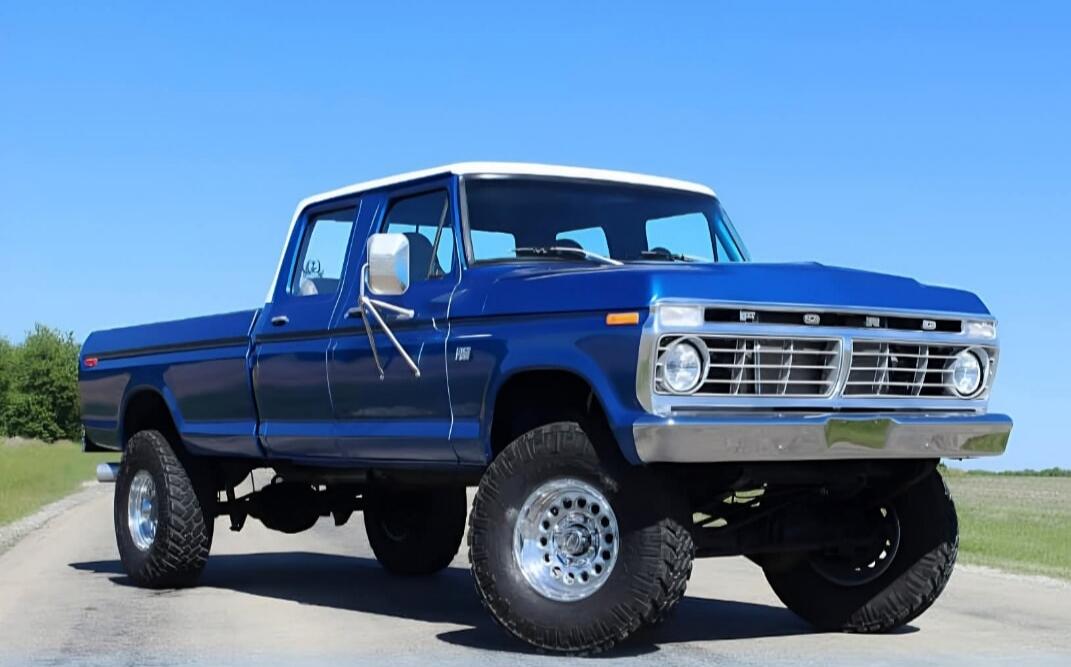Blue classic lifted pickup truck on a road