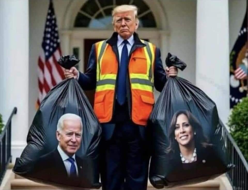A man wearing an orange safety vest carries two garbage bags with pictures of Biden and Obama.