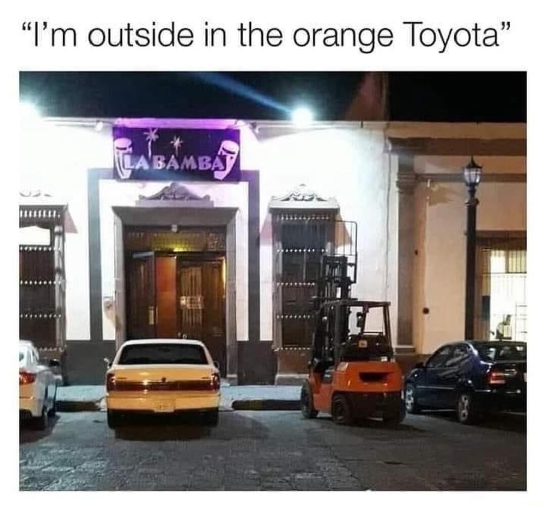 Im outside in the orange Toyota