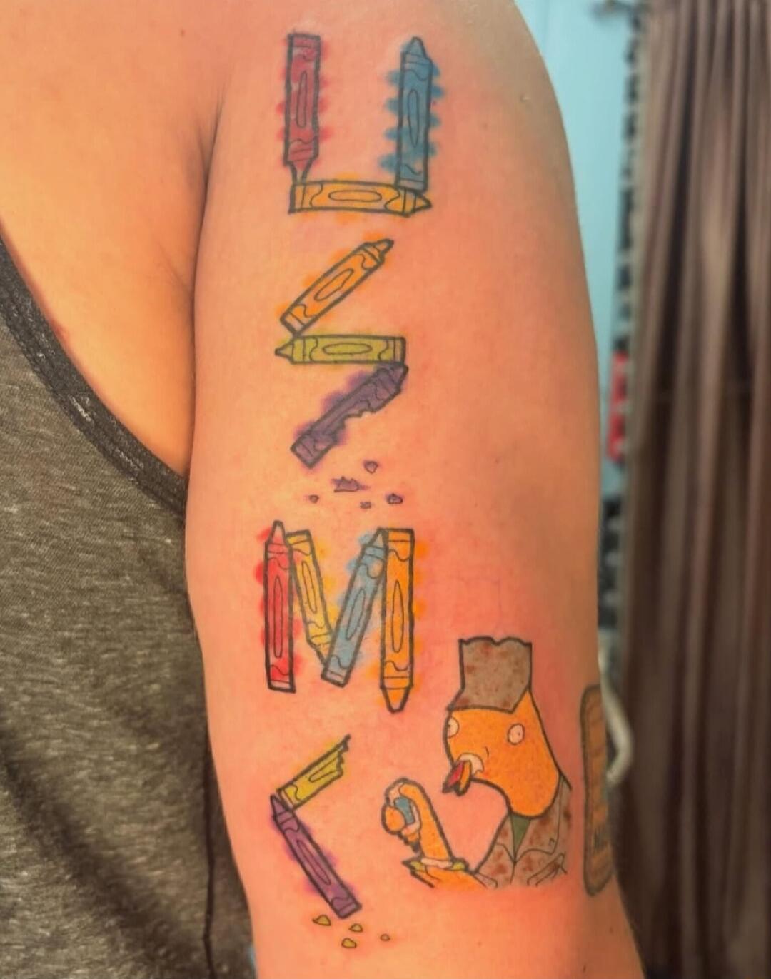 A tattoo on an arm depicting the acronym 