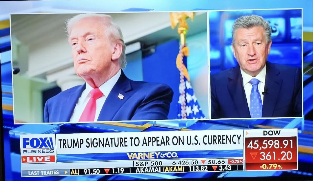 FOX Business Live reports that Trump's signature is to appear on U.S. currency. The broadcast features Donald Trump and a news anchor, with live stock market data including S&P 500, Dow, and Akamai. The headline reads: 