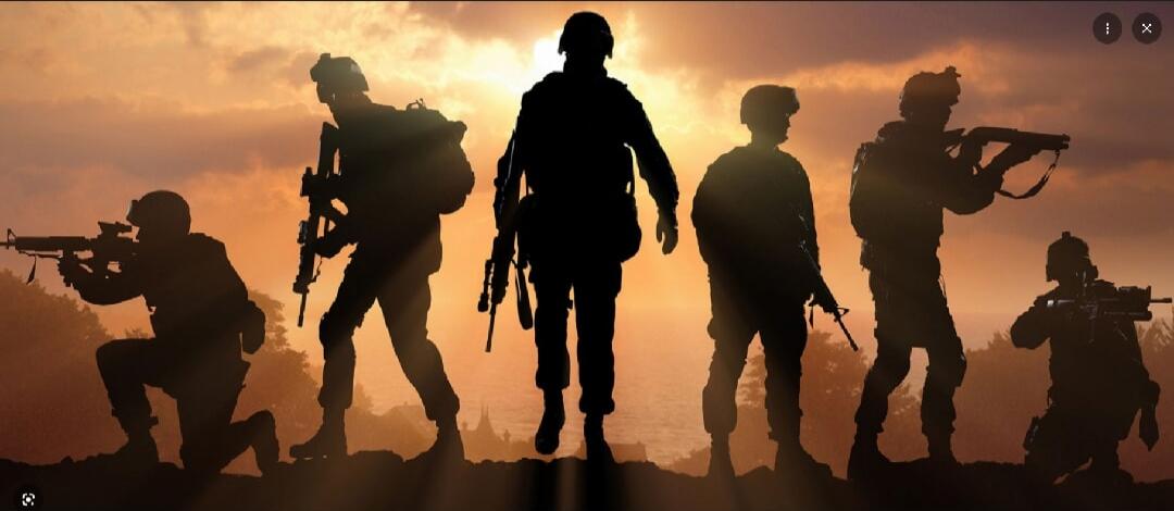 Silhouetted soldiers with rifles standing on a ridge at sunset.