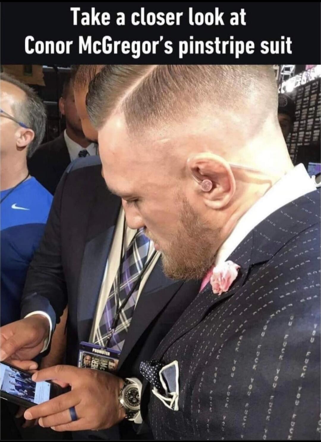 Take a closer look at Conor McGregor's pinstripe suit. The pinstripes on his suit are actually the words 'FUCK YOU' repeated multiple times.