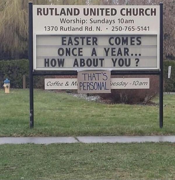 A church sign for Rutland United Church reads: 'Worship: Sundays 10am. 1370 Rutland Rd. N. • 250-765-5141. EASTER COMES ONCE A YEAR... HOW ABOUT YOU ?' Below the main sign, a cardboard piece is taped, stating: 'THAT'S PERSONAL'. Another partially visible sign below reads 'Coffee & M Tuesday - 10am'.
