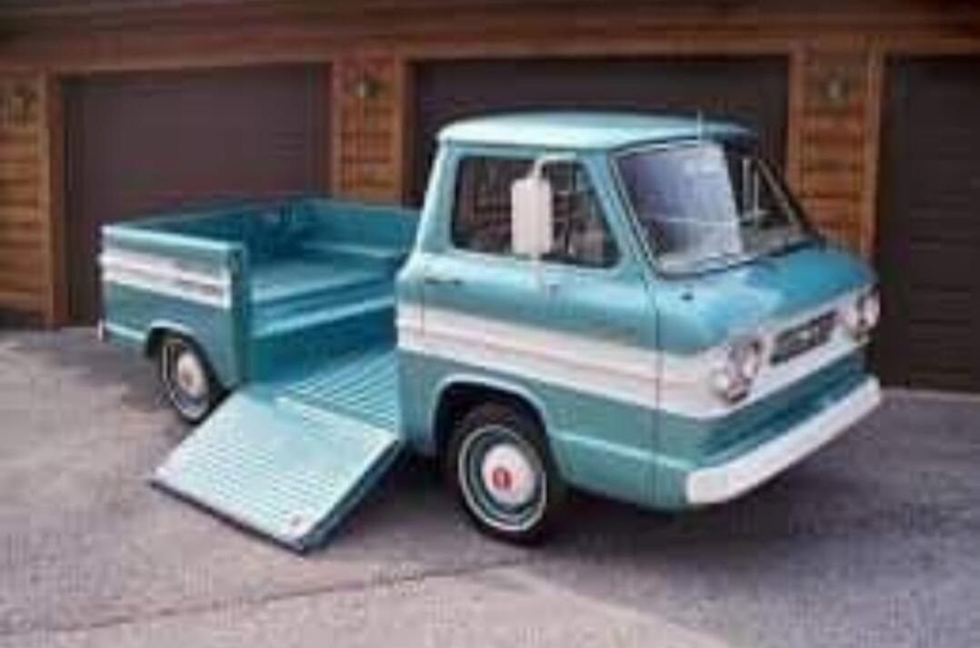 turquoise vintage pickup truck with a loading ramp