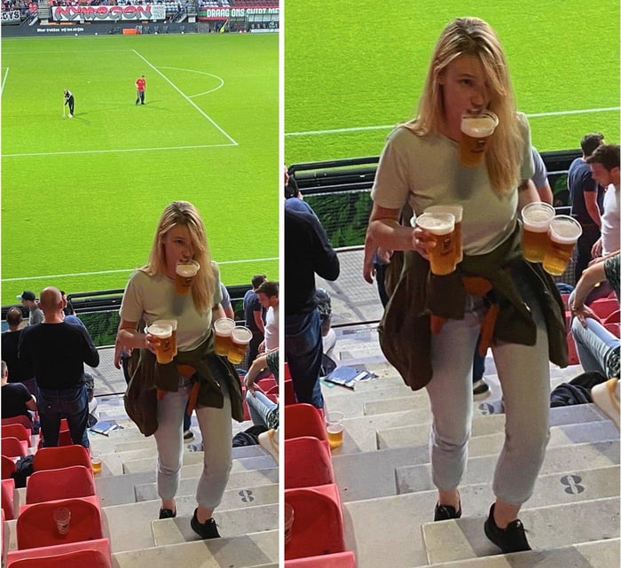 A woman carrying multiple beers up stadium stairs.