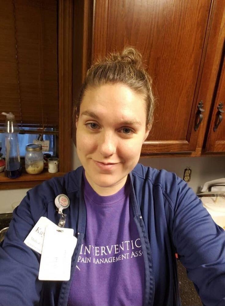 Interventional Pain Management Assoc (shirt). Name badge visible with unreadable text. Session ID: 989497.