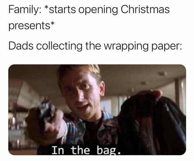 Family starts opening Christmas presents Dads collecting the wrapping paper