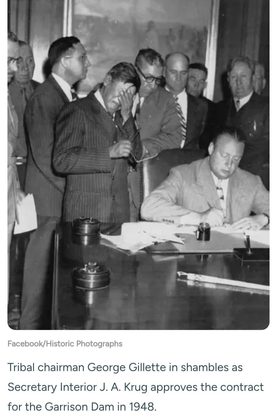 Tribal chairman George Gillette in shambles as Secretary Interior J. A. Krug approves the contract for the Garrison Dam in 1948.