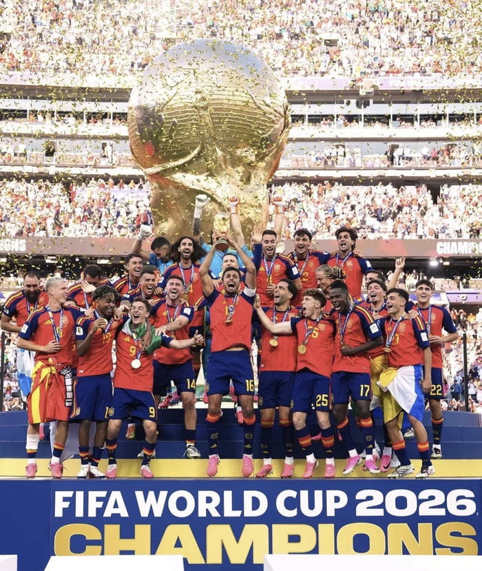 FIFA WORLD CUP 2026 CHAMPIONS. A group of football players, likely the Spanish national team, are celebrating their victory with the World Cup trophy and medals, surrounded by confetti in a stadium.