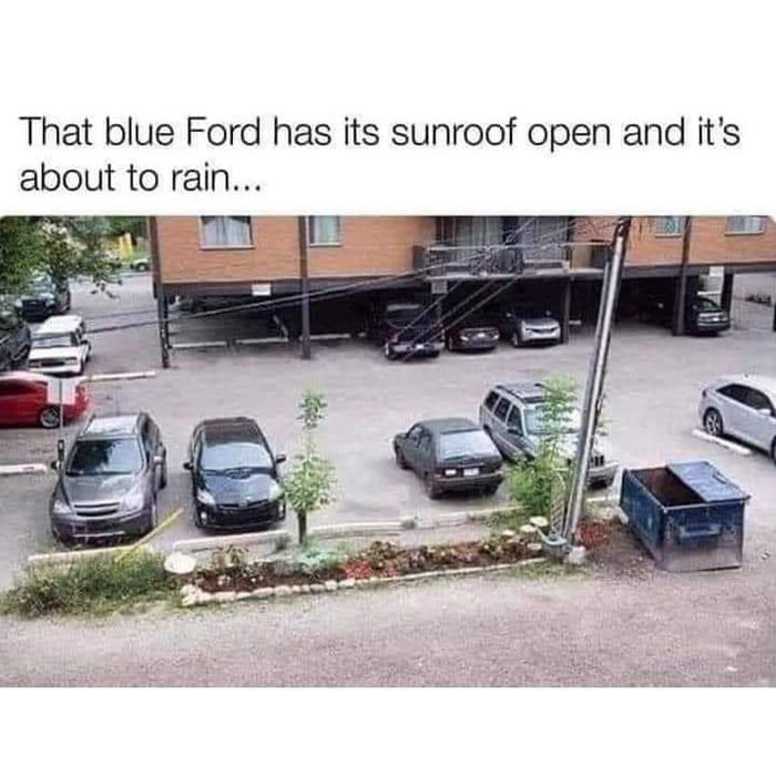 That blue Ford has its sunroof open and its about to rain