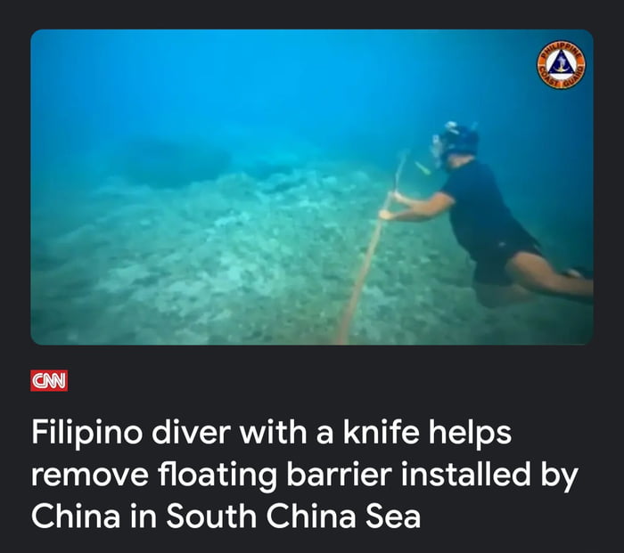 PRS 0 N Filipino diver with a knife helps remove floating barrier installed by China in South China Sea