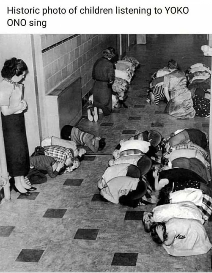 Historic photo of children listening to YOKO ONO sing