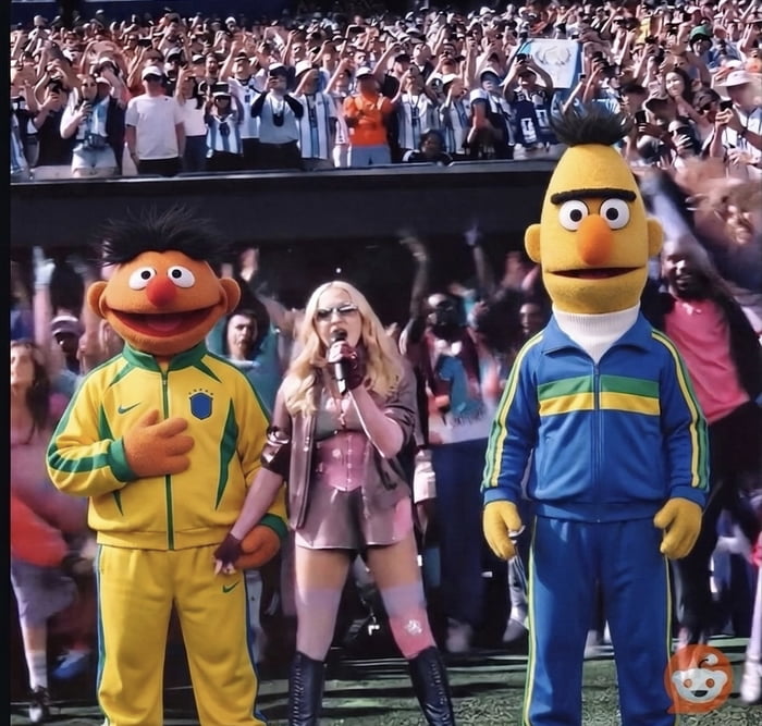 Madonna performing on stage with two characters resembling Ernie and Bert from Sesame Street, dressed in tracksuits with Brazilian flag colors. A large crowd, some wearing Argentina football jerseys, is visible in the background.