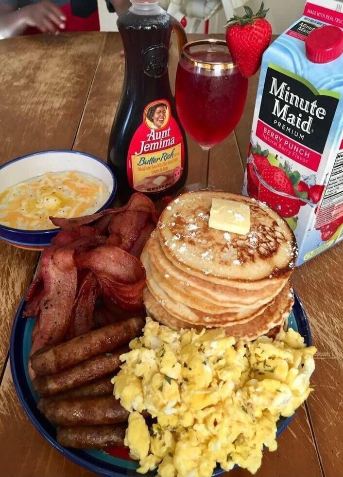 Aunt Jemima syrup bottle, Minute Maid Berry Punch juice, pancakes with butter, scrambled eggs, bacon, sausages, hash browns