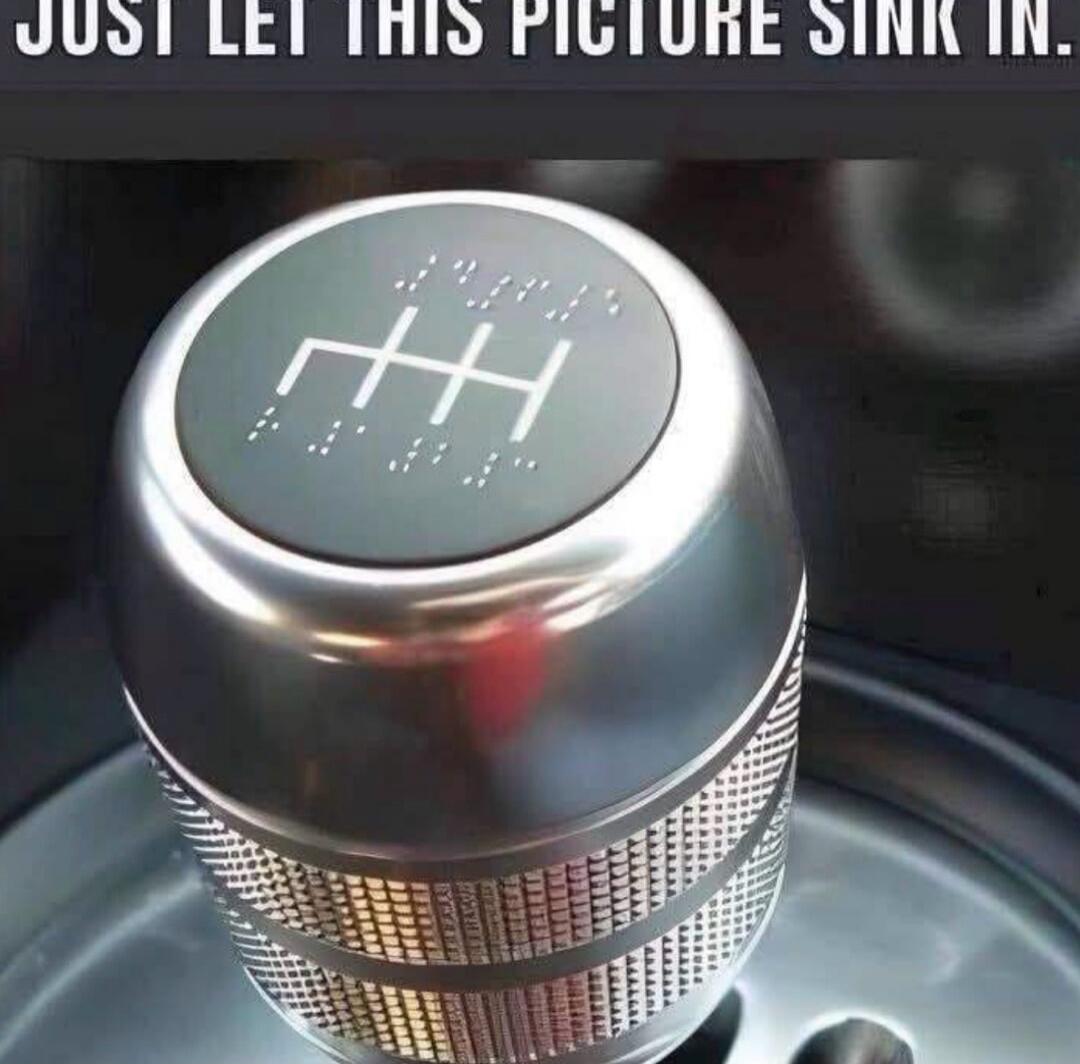JUST LET THIS PICTURE SINK IN. A car's manual gear shift knob with gear numbers (1, 2, 3, 4, 5, R) written in Braille.