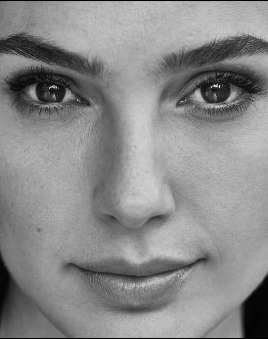 Close-up portrait of a woman's face (black and white).