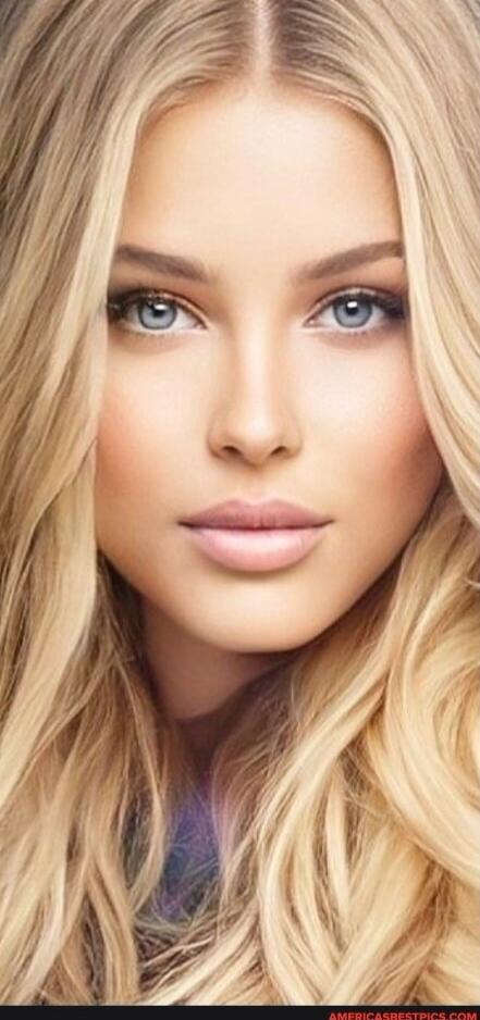 Close-up portrait of a blonde woman with blue eyes.