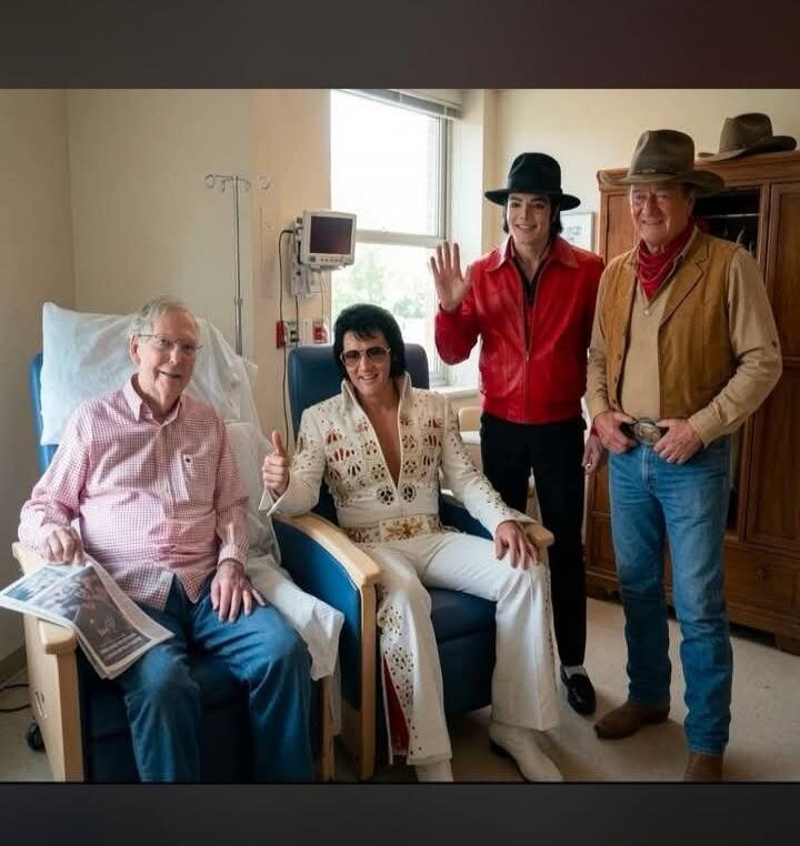 An older man in a hospital room is visited by impersonators of Elvis Presley, Michael Jackson, and a cowboy. The man dressed as Elvis gives a thumbs-up, and the man dressed as Michael Jackson waves.