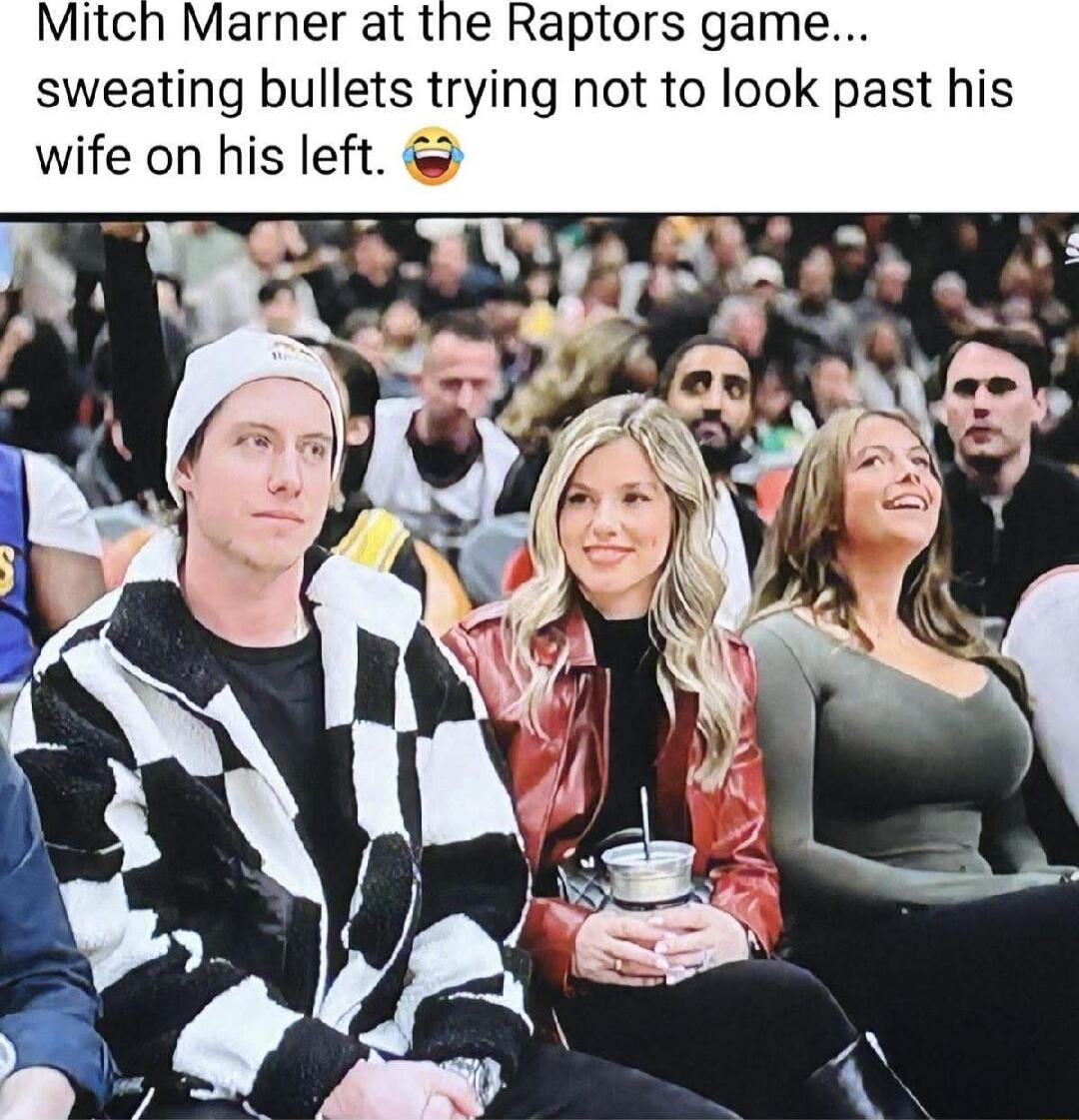 Mitch Marner at the Raptors game sweating bullets trying not to look past his wife on his left