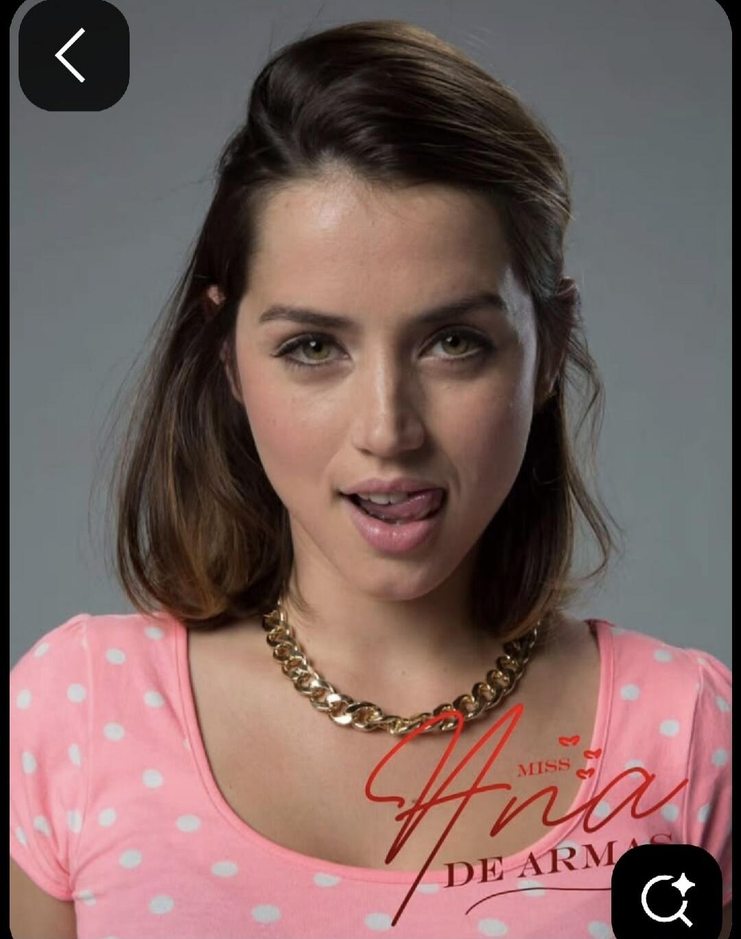 MISS Ana DE ARMAS. A portrait of actress Ana de Armas, looking playfully at the camera with her tongue slightly out, wearing a pink polka-dot top and a gold chain necklace.