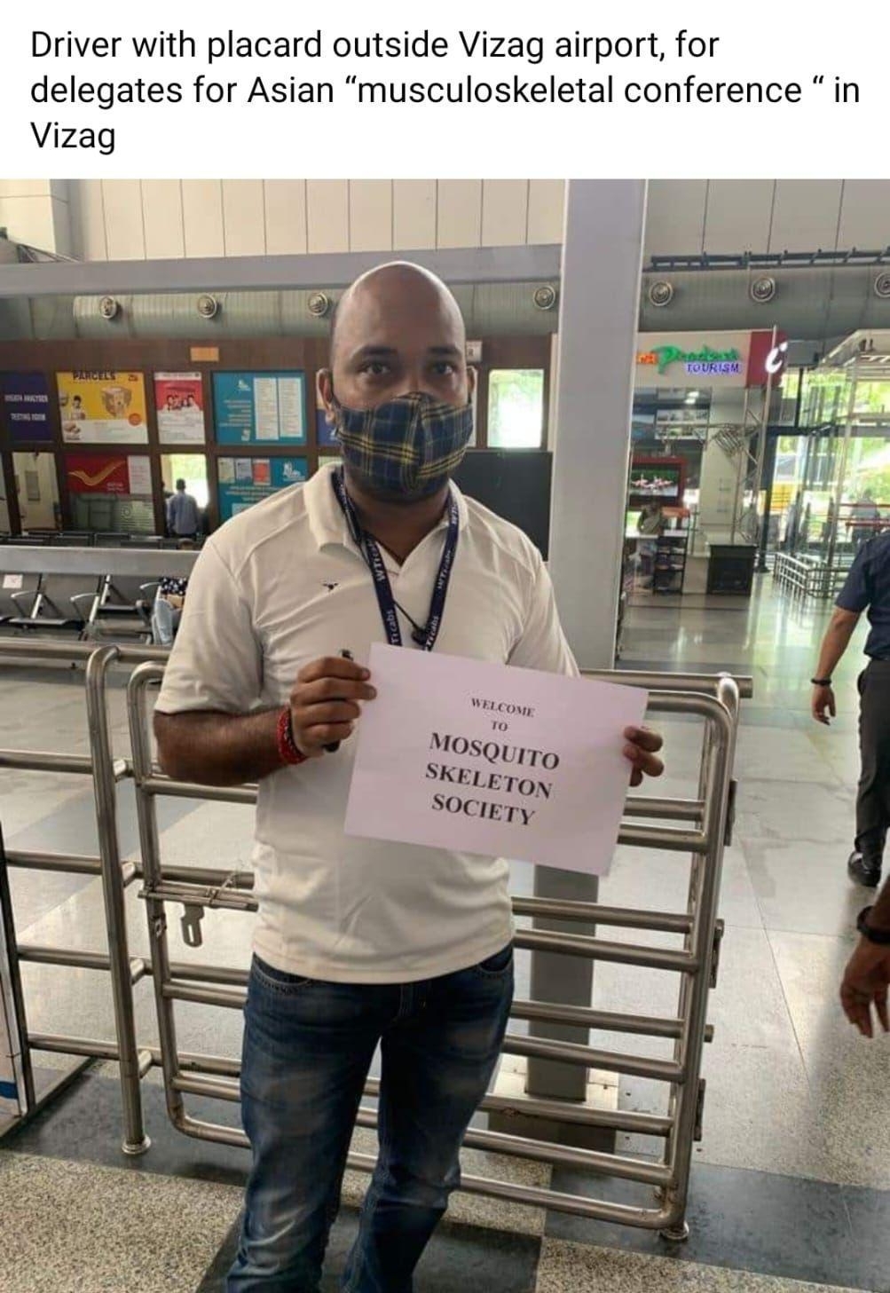 Doctorscoin TR s om Q Driver with placard outside Vizag airport for delegates for Asian musculoskeletal conference in Vizag