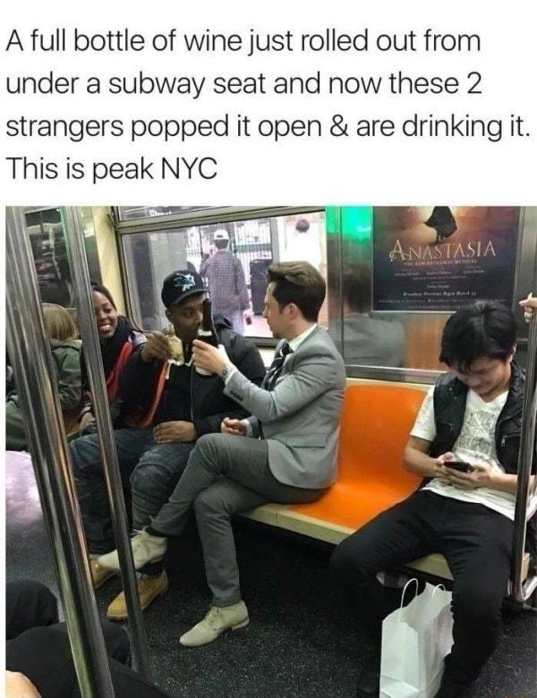 A full bottle of wine just rolled out from under a subway seat and now these 2 strangers popped it open are drinking it This is peak NYC