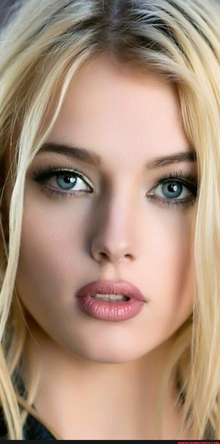 Close-up portrait of a blonde woman with blue eyes.