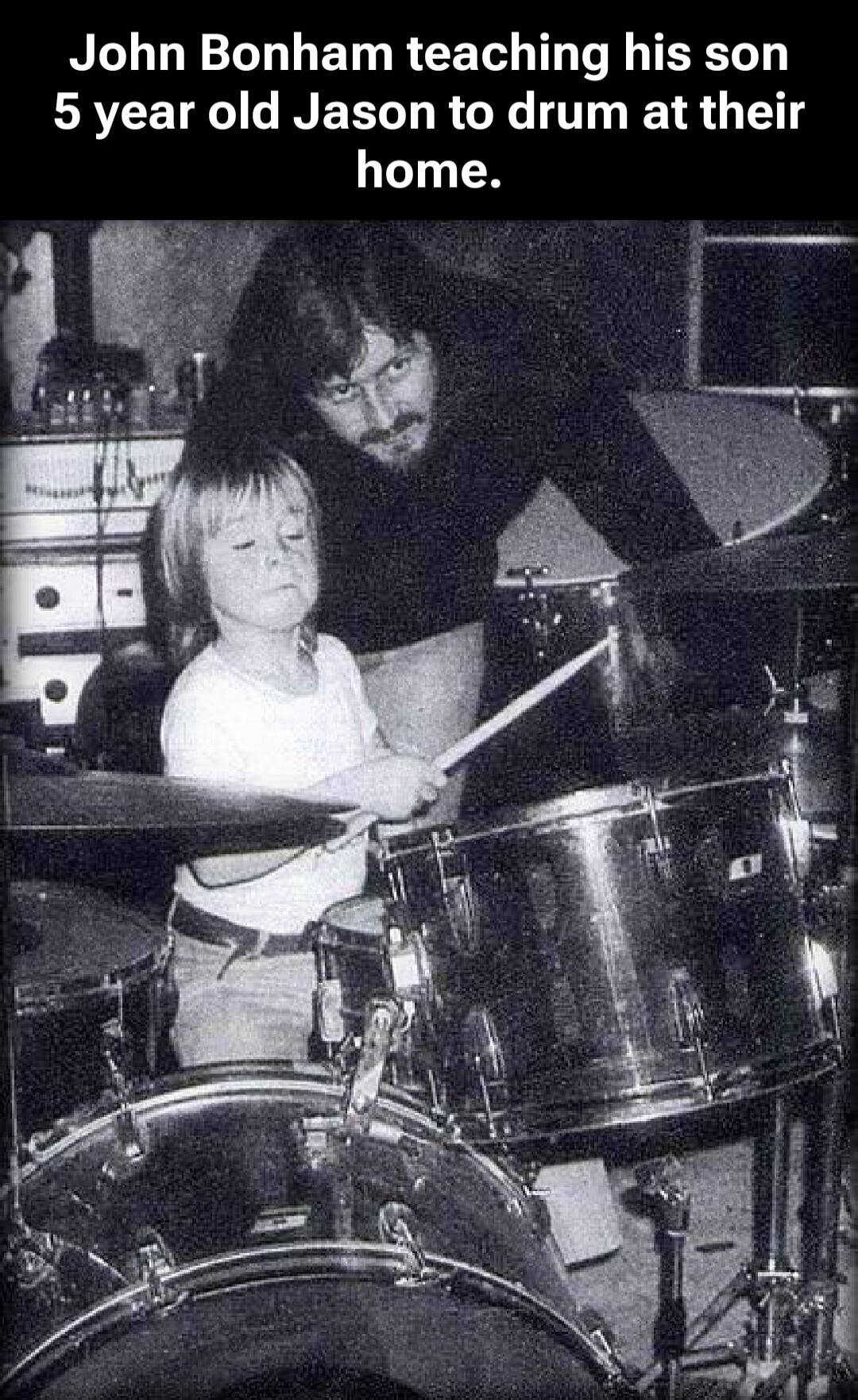 John Bonham teaching his son 5 year old Jason to drum at their home.