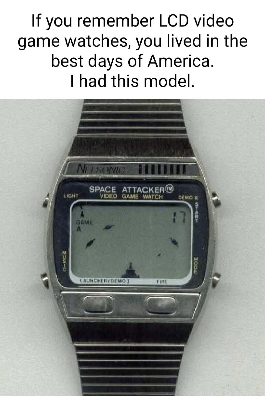 If you remember LCD video game watches, you lived in the best days of America. I had this model. The watch itself is a NU SONIC SPACE ATTACKER™ VIDEO GAME WATCH, showing 'GAME A' with a launcher and alien-like figures, and buttons for LIGHT, MUSIC, LAUNCHER/DEMO I, FIRE, START, MODE, DEMO B.