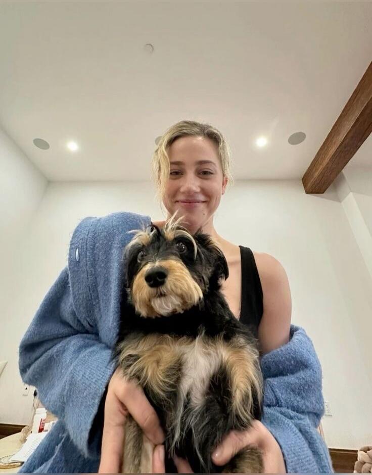 A woman holding a small dog.