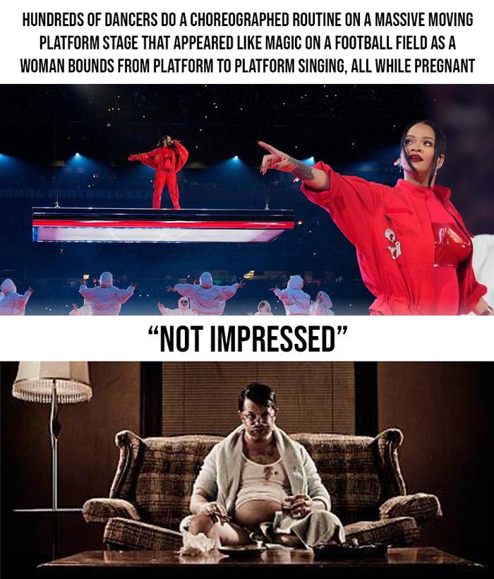 HUNDREDS OF DANCERS DO A CHOREOGRAPHED ROUTINE ON A MASSIVE MOVING PLATFORM STAGE THAT APPEARED LIKE MAGIC ON A FOOTBALL FIELD AS A WOMAN BOUNDS FROM PLATFORM TO PLATFORM SINGING ALL WHILE PREGNANT