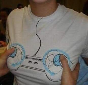 A person wearing a white t-shirt with a gamepad design, where hands are pressing on the shirt to make the 'joysticks' protrude over the chest area.