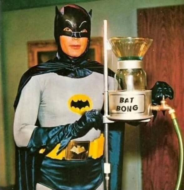Batman holding a device labeled BAT BONG.