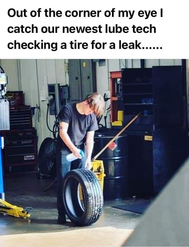 Out of the corner of my eye catch our newest lube tech checking a tire for a leak