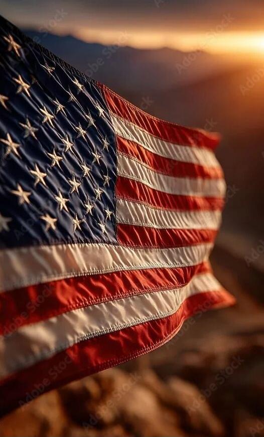 American flag waving in the wind at sunset.
