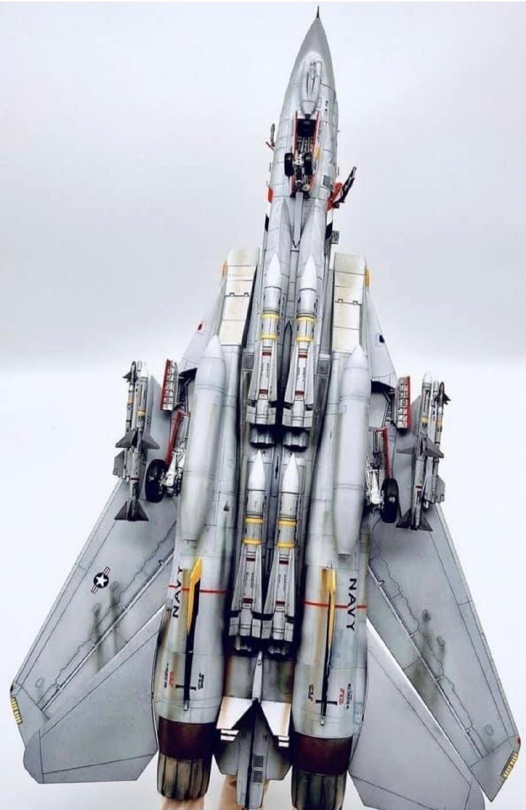 Top-down view of a model fighter jet (toy) with Navy markings.