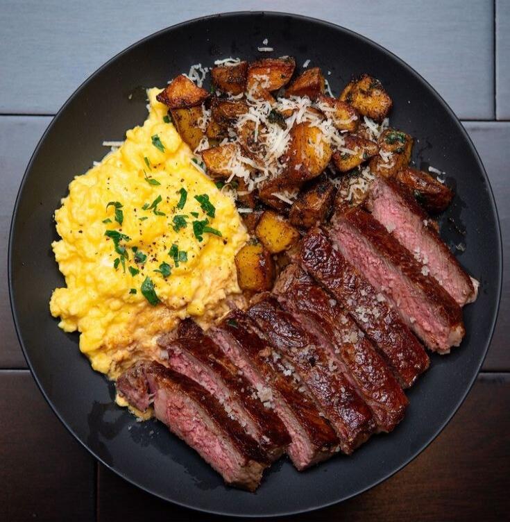 Scrambled eggs, steak, and potatoes.