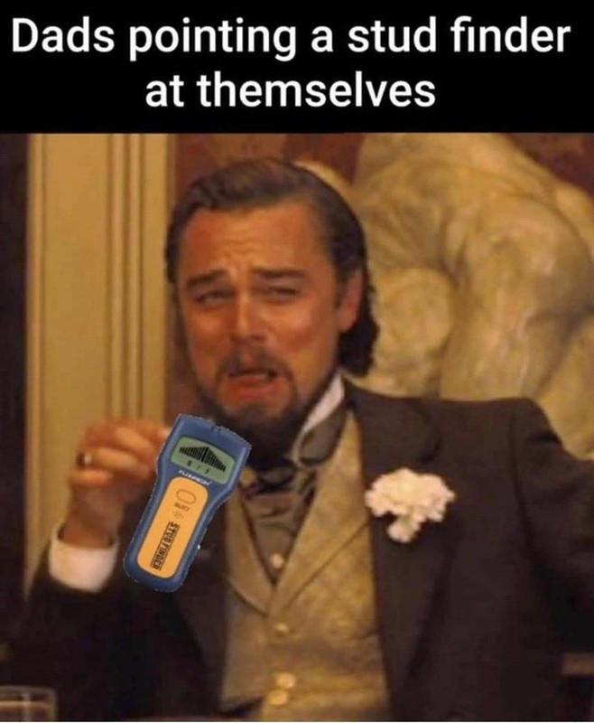 Dads pointing a stud finder at themselves